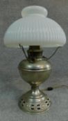 A vintage oil lamp with original milk glass shade. H.44cm