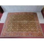 A large Persian Afshar style rug with allover floral motifs on a yellow ground within floral and