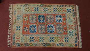 A Persian rug with tile pattern, framed by borders and fringed 163x103cm