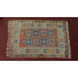 A Persian rug with tile pattern, framed by borders and fringed 163x103cm