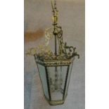 An antique French pierced brass hanging lantern with cross hatched cut glass panels. 60x35cm