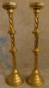 A pair of Gothic style ecclesiastic brass twist stem candle sticks. H.80cm