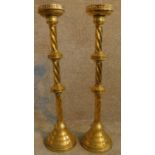 A pair of Gothic style ecclesiastic brass twist stem candle sticks. H.80cm