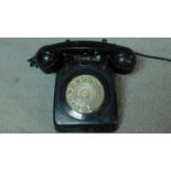 A vintage black bakelite dial phone. 25x21cm