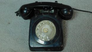 A vintage black bakelite dial phone. 25x21cm