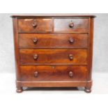 A Victorian mahogany chest of two short over three long drawers, raised on squat turned supports.