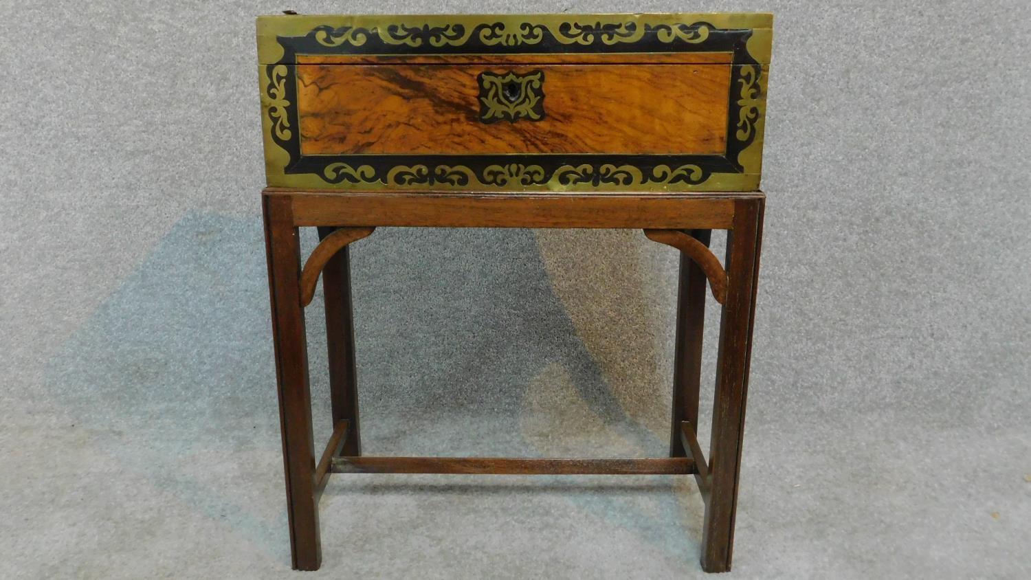 A Victorian walnut writing box with ebony and brass decoration and gilded tooled red leather