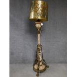 A ceramic and brass tall standard lamp with gilded and hand painted floral design. H.178cm