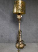 A ceramic and brass tall standard lamp with gilded and hand painted floral design. H.178cm