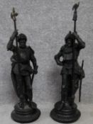 A pair of late 19th century cast spelter figures of armoured knights on round embossed detailed
