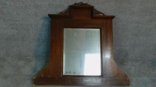 A carved walnut framed overmantel mirror. 102x110cm