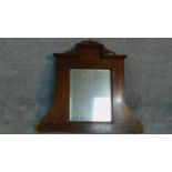 A carved walnut framed overmantel mirror. 102x110cm