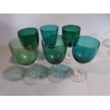 Two sets of antique coloured glasses. One set of six hand blown grey blue stemmed port glasses along