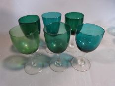 Two sets of antique coloured glasses. One set of six hand blown grey blue stemmed port glasses along