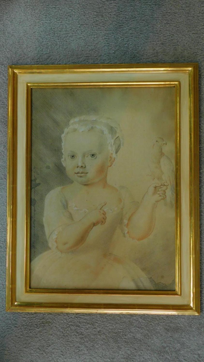 A framed pastel and watercolour depicting a child holding a bird. 57x43cm