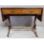 A Regency style mahogany drop flap sofa table with two dummy drawers opposing a pair of drawers.