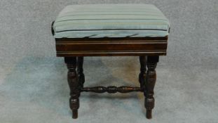 An Edwardian mahogany adjustable piano stool raised on stretchered turned tapering supports. H.46