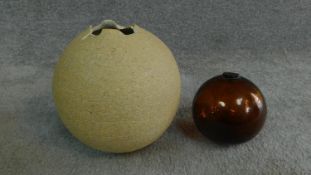 An antique blown glass fishing float along with a studio pottery abstract glazed vase. With makers