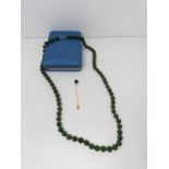 A nephrite necklace with a 10 carat gold clasp. Comprises of 72 round polished nephrite beads, all