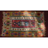A kelim rug, with geometric motifs surrounded by polychrome multi borders 182x111cm