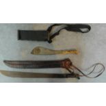 Two vintage machetes. The larger blade has a leather sheath and is stamped Imacasa on the handle.