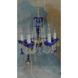 A Victorian Bohemian cobalt glass chandelier with gilded decoration and cut crystal swags and drops.