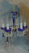 A Victorian Bohemian cobalt glass chandelier with gilded decoration and cut crystal swags and drops.