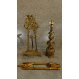 A collection of brass items and a giltwood gothic style mirror. A pierced brass floor candlestick