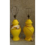 A pair of pale yellow ceramic table lamps. H.62cm