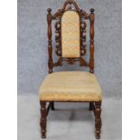 A Victorian oak chair with floral carving to the back and woven peacock feather design upholstery