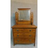 A late 19th century oak three drawer dressing chest with leaf carving and raised on bracket