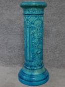 A Victorian blue glazed ceramic Burmantofts jardinere stand with sunflower decoration. H.69cm