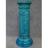 A Victorian blue glazed ceramic Burmantofts jardinere stand with sunflower decoration. H.69cm