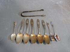 A collection of silver cutlery including a pair of Georgian sugar tongs, five continental silver