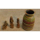 A trio of antique carved wooden figures and a painted polychrome turned vase. H.28cm