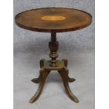 An Edwardian mahogany wine table with urn inlay raised on fluted quadruped supports. H.55cm