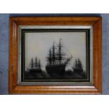 A late 19th century maple framed reverse painted glass picture depicting "H.M.S. Victory" and two