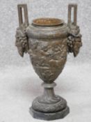 An antique bronze twin handled urn of classical form with cherub and satyr motifs. H.40cm