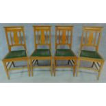 A set of four Art Nouveau oak chairs with carved back and green leather upholstery raised on
