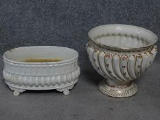 A pair of antique porcelain planters. One with gilded and floral decoration. Makers stamp to the