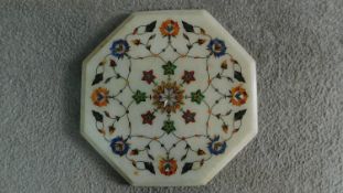 An Indian pietra dura inlaid white marble board. Inlaid with various precious gemstones such as