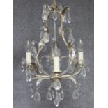 A four branch chandelier on naturalistic metal frame and crystal drops. 70x35cm