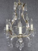 A four branch chandelier on naturalistic metal frame and crystal drops. 70x35cm