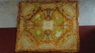 An ornate and intricately detailed geometric design rug with cherubs, framed with fan motifs and