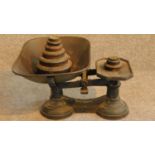 A vintage set of green painted iron grocers scales with its set of weights. 20x36cm