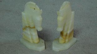 A pair of vintage carved alabaster horse head bookends. H.18cm