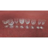 Eight engraved Victorian stemmed drinking glasses. A pair of port glasses with oval faceted