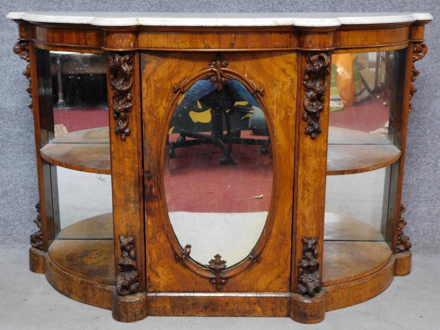 A 19th century marble topped and mirrored burr walnut credenza with floral carvings on shaped plinth