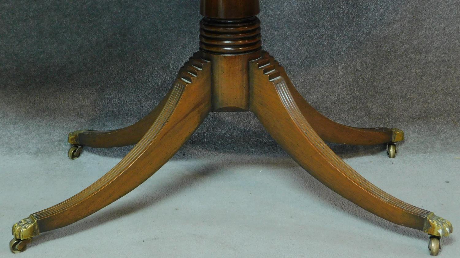 A Regency style mahogany dining table raised on fluted swept quadruped supports. H.79 W.169 D.84cm - Image 3 of 7