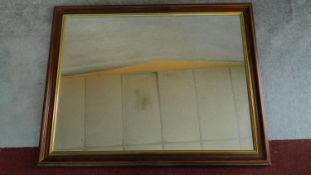 A large rectangular gilt and mahogany framed wall mirror. 92x115cm